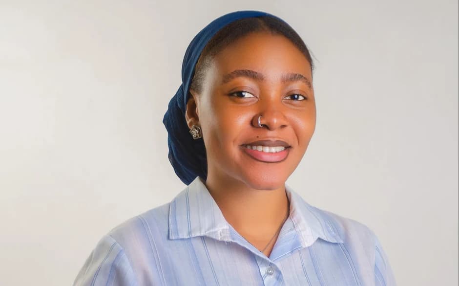 Sarah, an account manager, in a blue headscarf