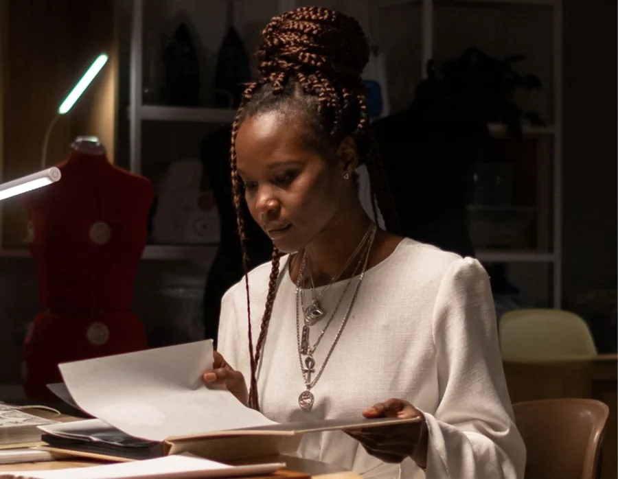 Designer reviewing printed layouts at a studio desk