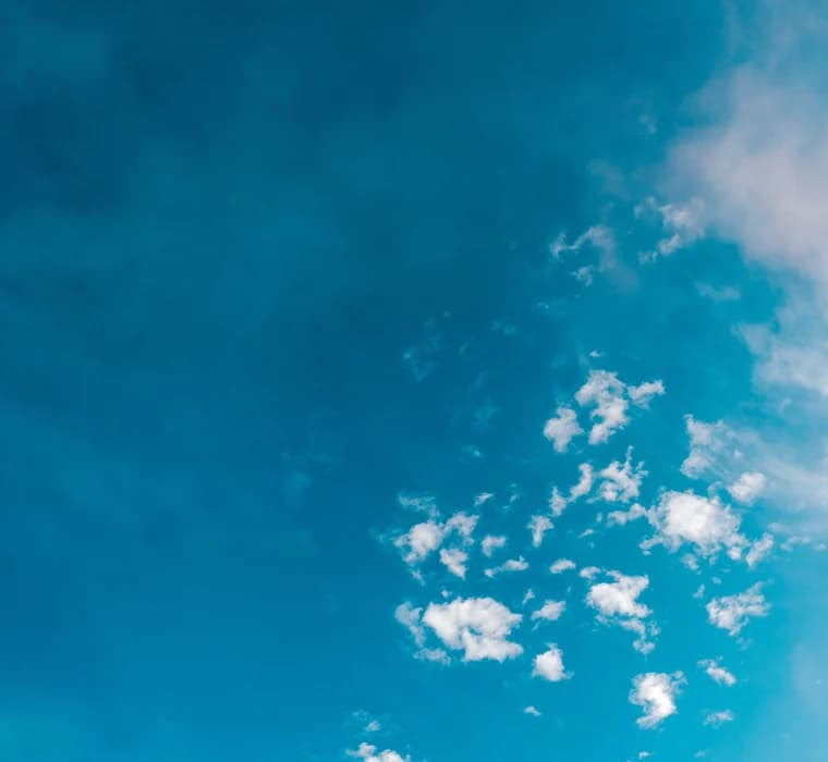 Bright blue sky scattered with cloud