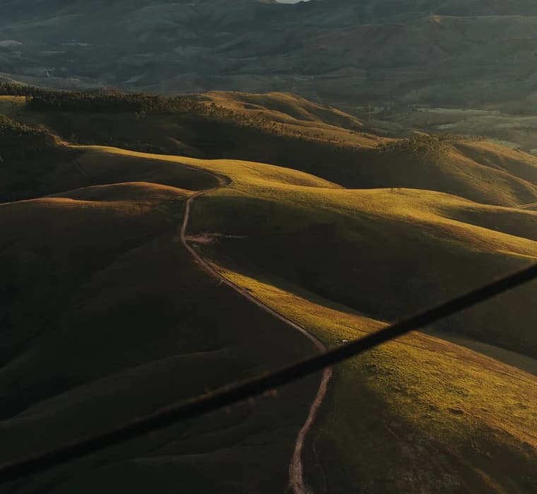 Rolling green hills crossed by a single track