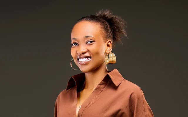 A smiling candidate in a rust-coloured shirt